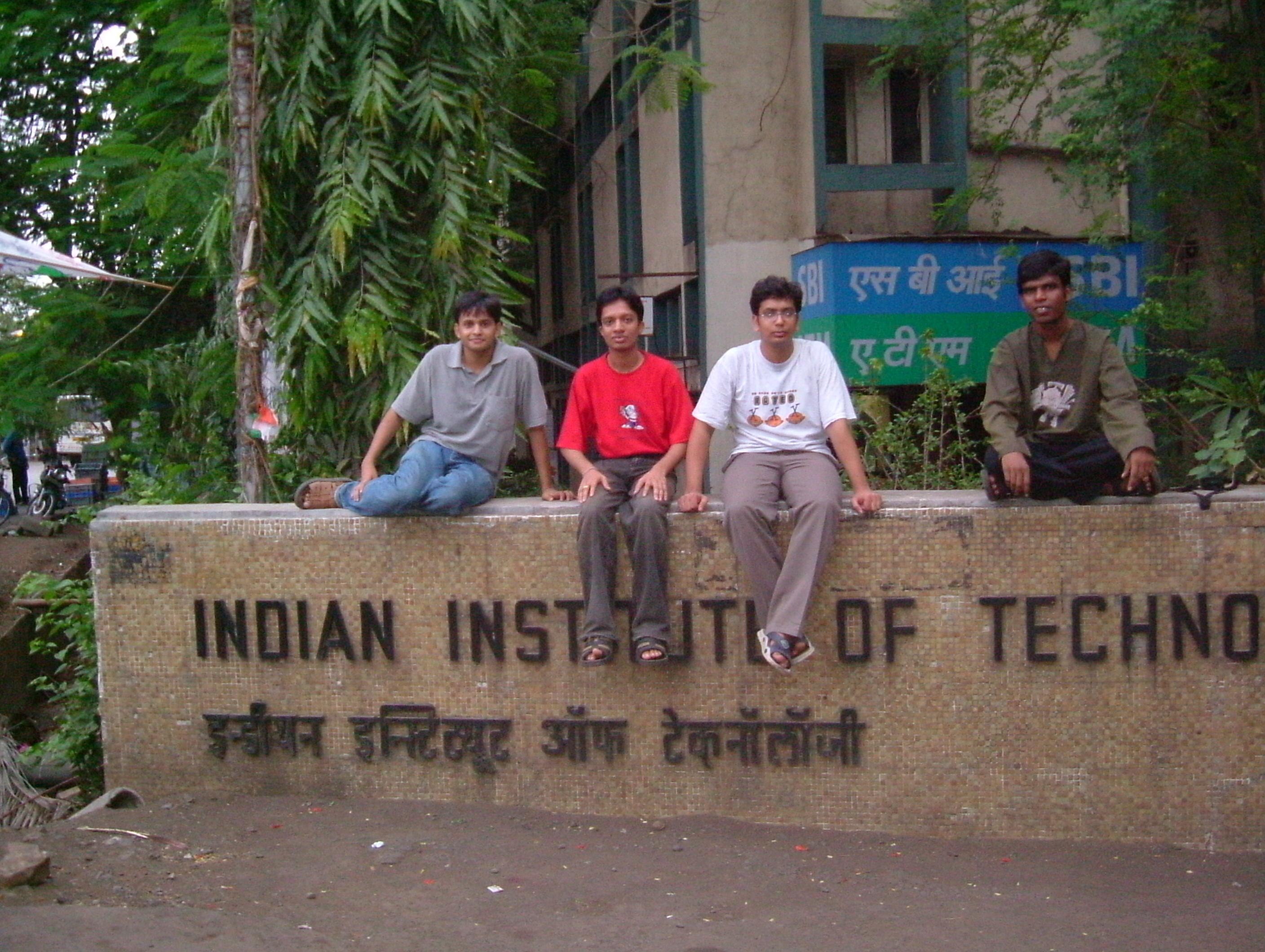 Friends seated in front of the Indian Institute of Technology Bombay sign