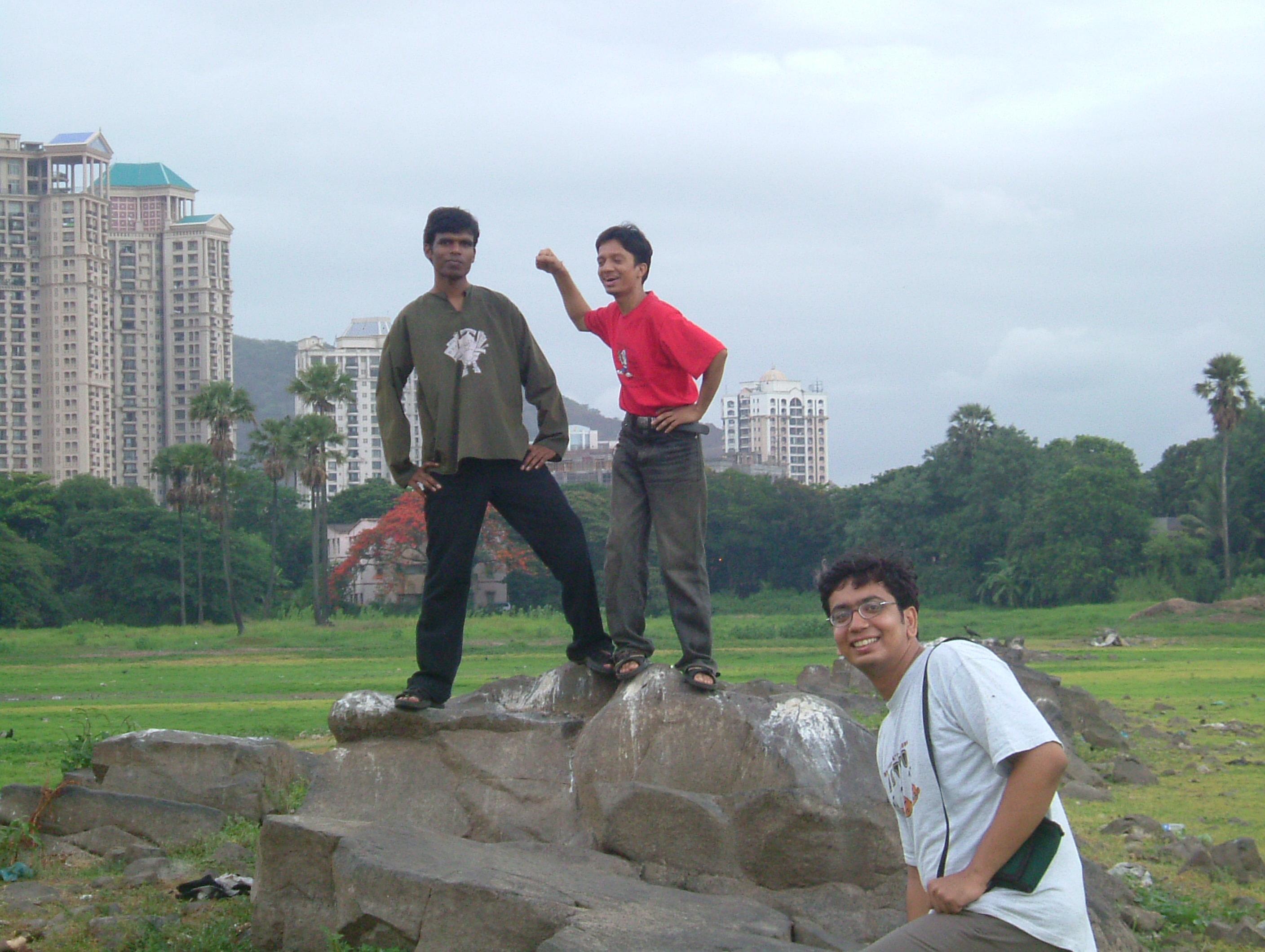 College friends posing on rocks near Powai Lake