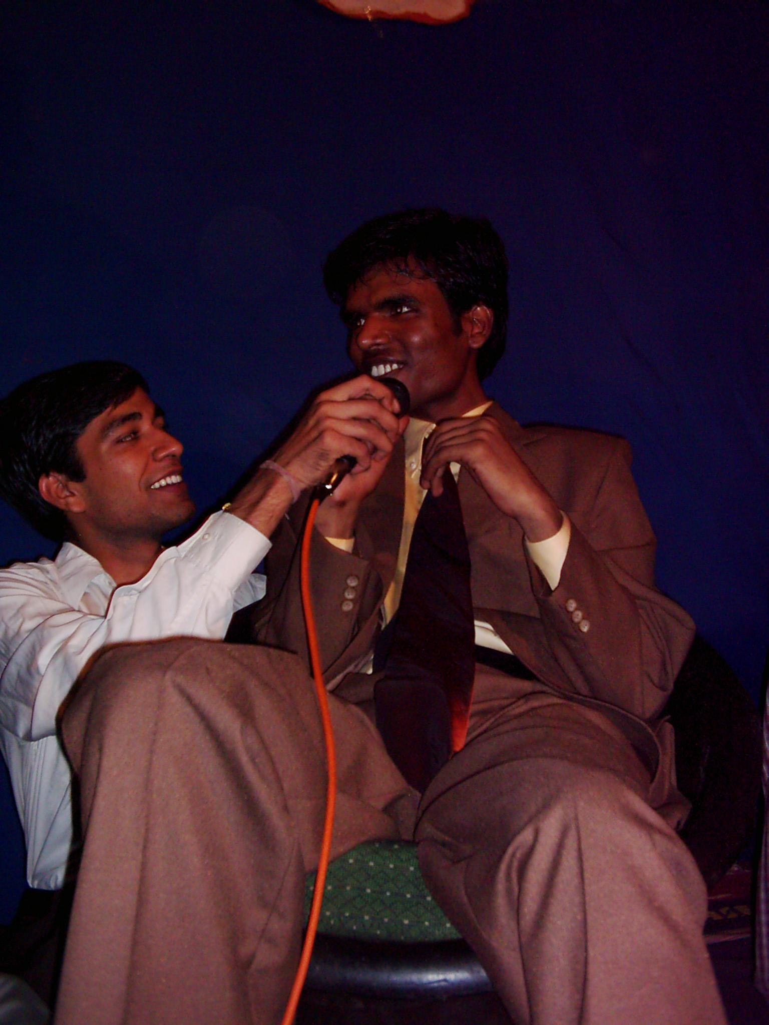 Pradeep Nagar sharing a microphone with a college friend