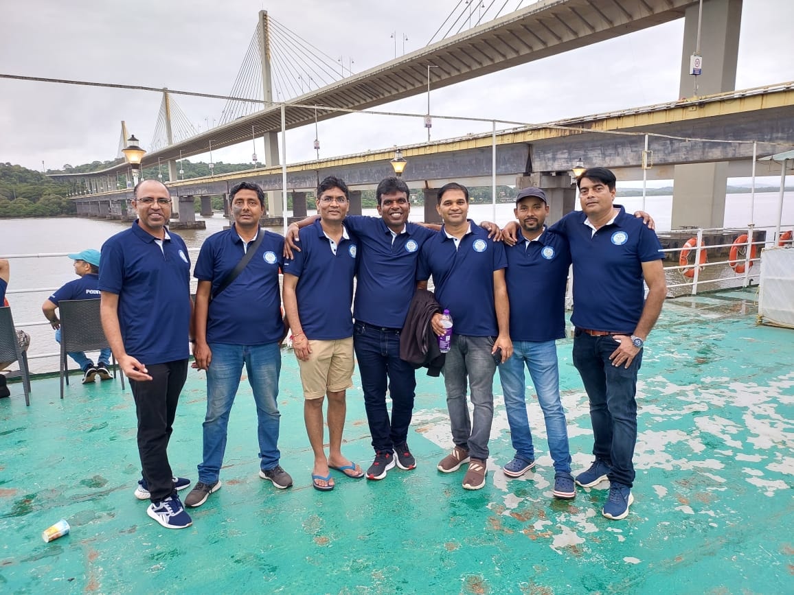 DRDO friends together on a boat beneath a bridge