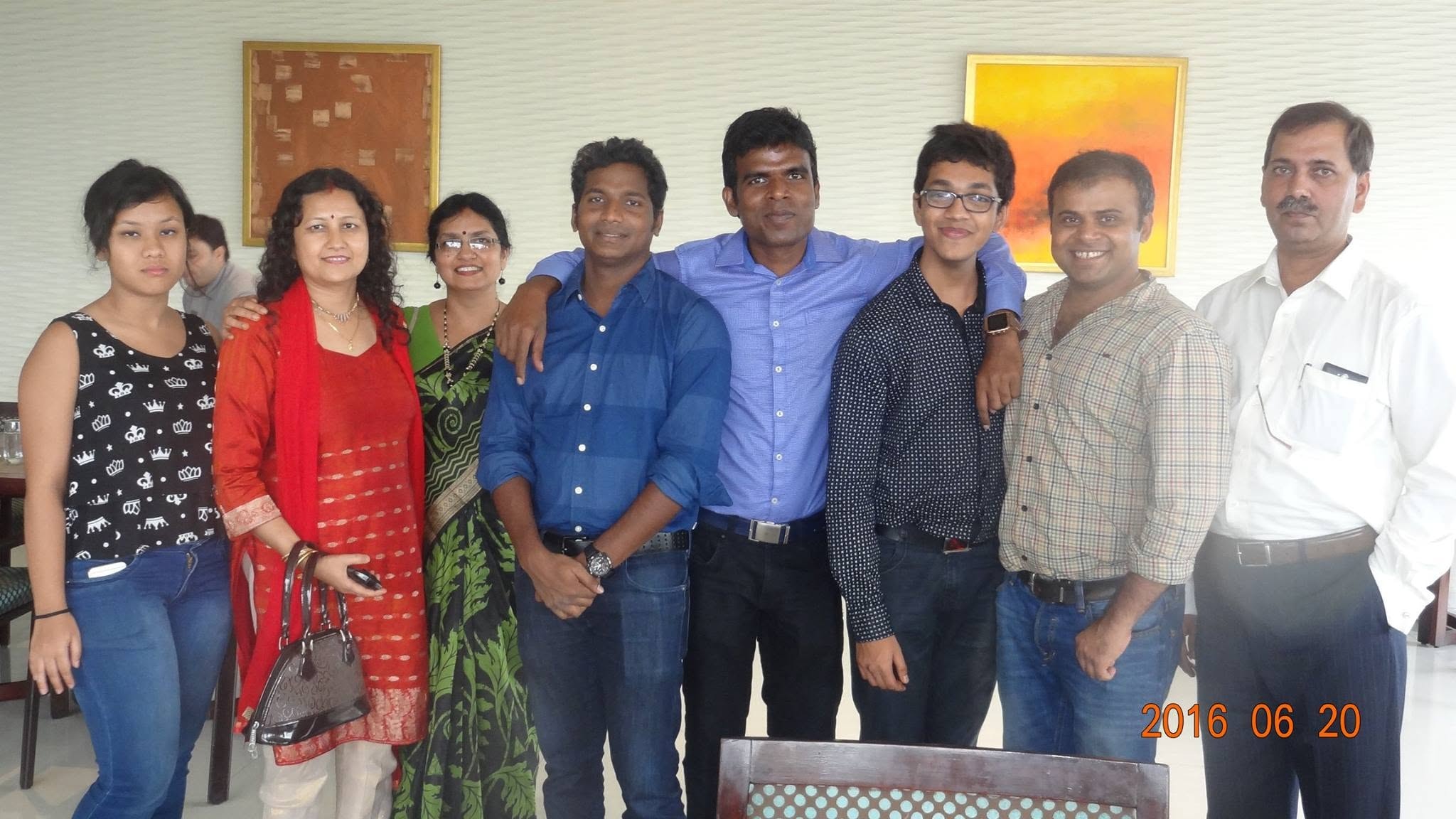Friends and colleagues gathered together indoors in 2016
