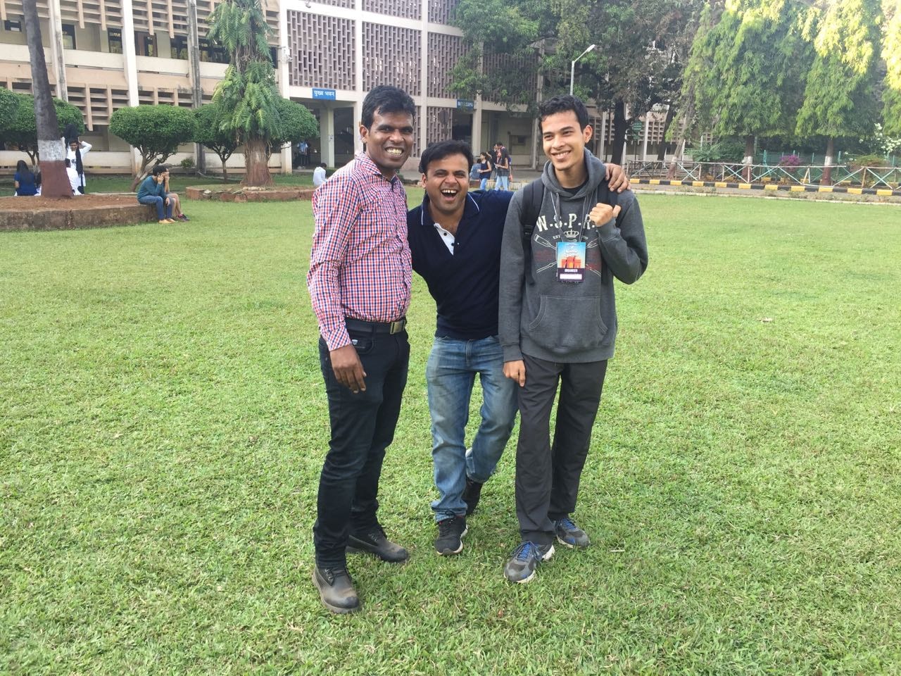 Friends celebrating together on a campus lawn