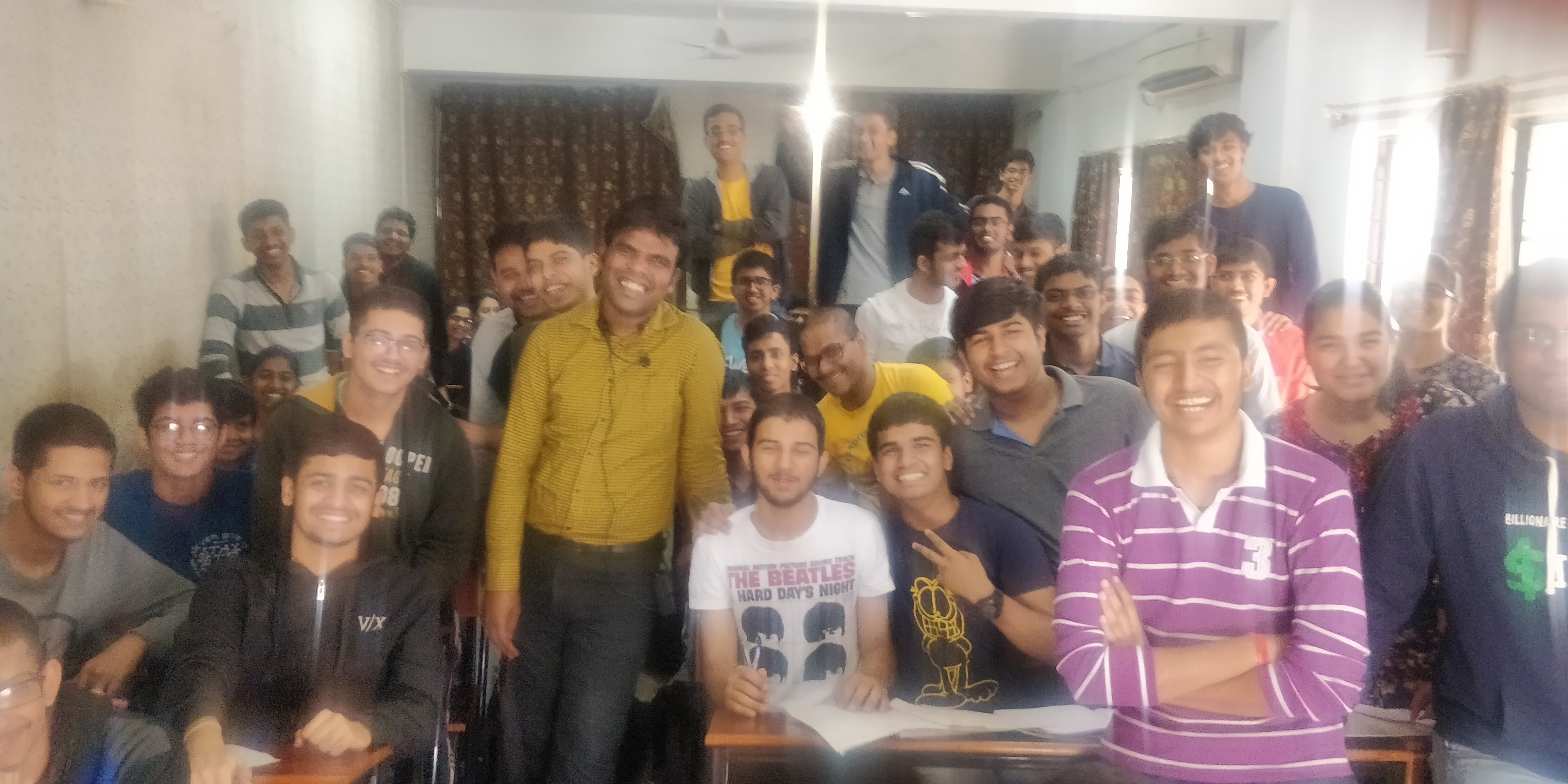 Large classroom community gathered with their teacher