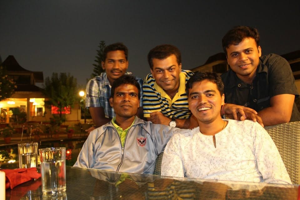 Friends smiling together at an outdoor restaurant