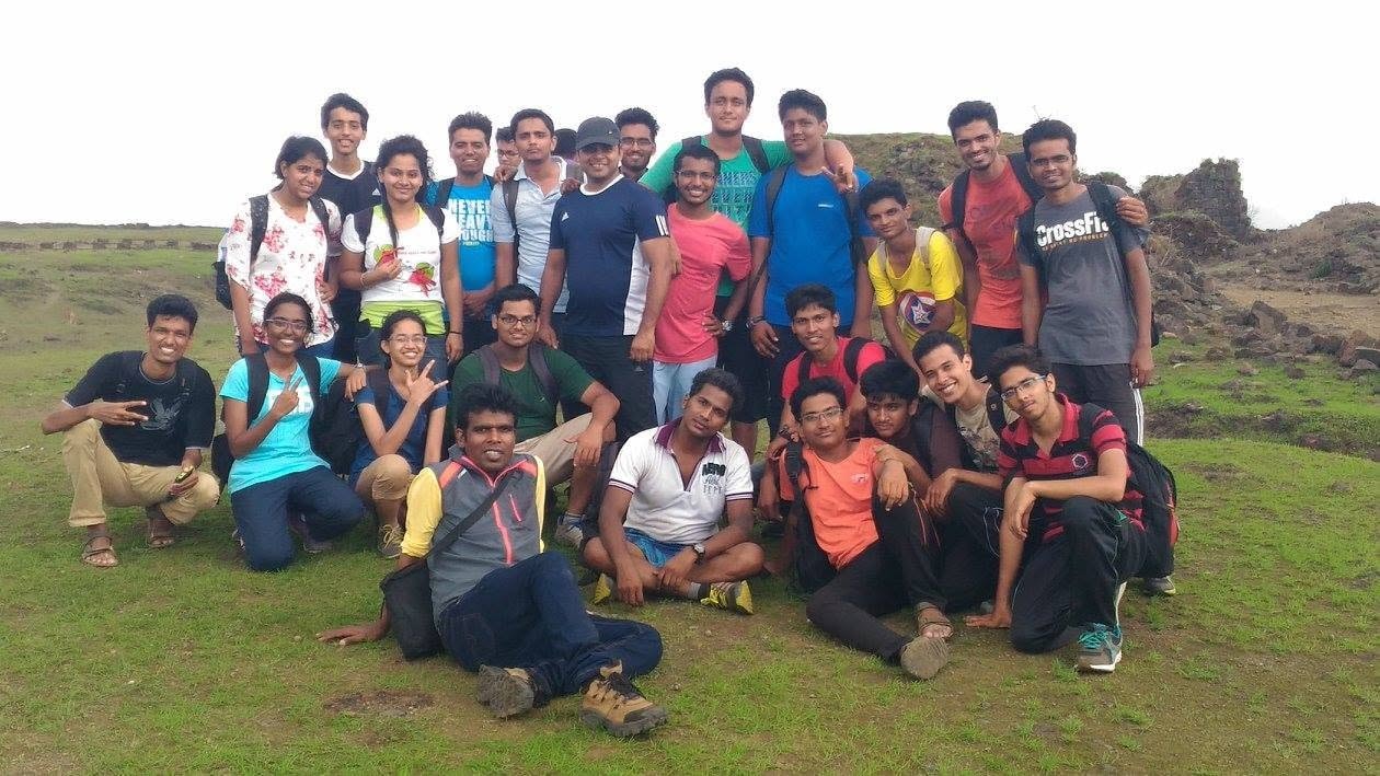 Large group gathered on a grassy hillside