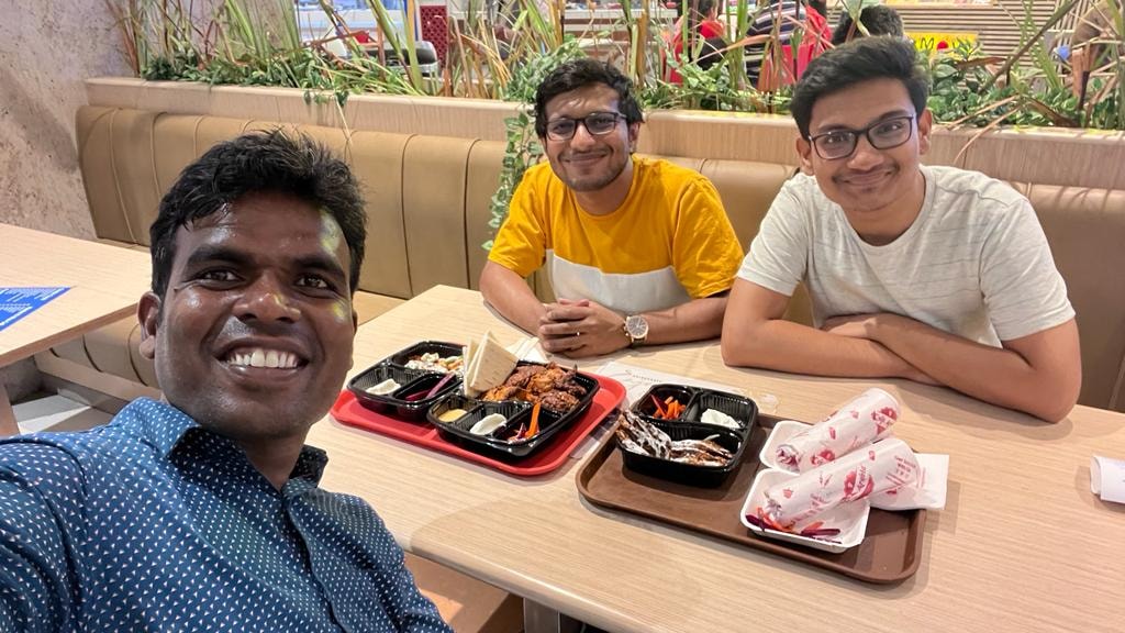 Pradeep Nagar taking a restaurant selfie with friends